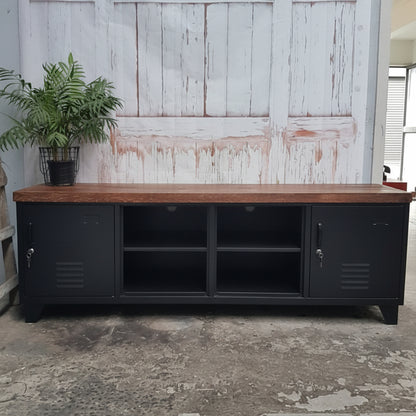 Large industrial TV cabinet with Dark Oak top in black with open display against a wood wall