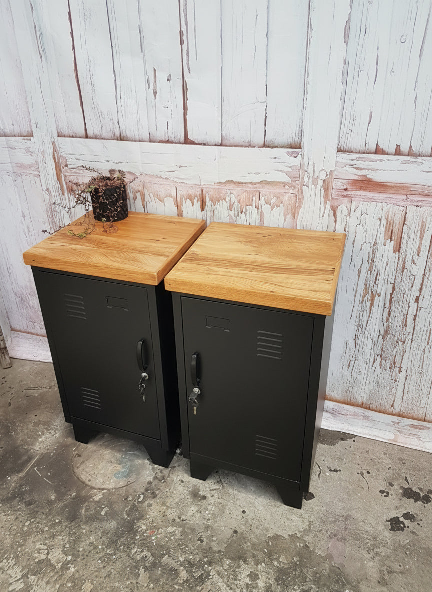 Pair of small black metal lockers with NZ Recycled Rimu tops against a rustic white wall.