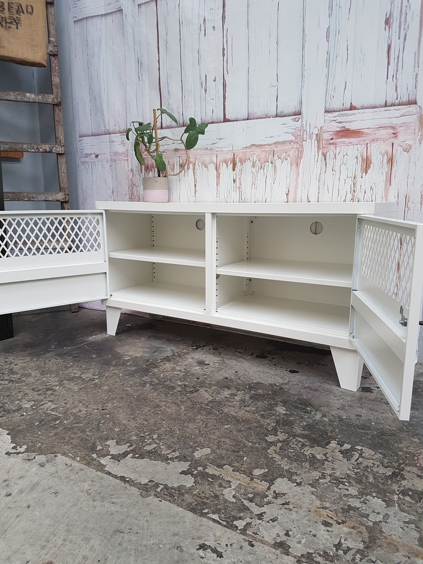 White Metal TV Cabinet. Doors open to show adjustable shelves and cable holes
