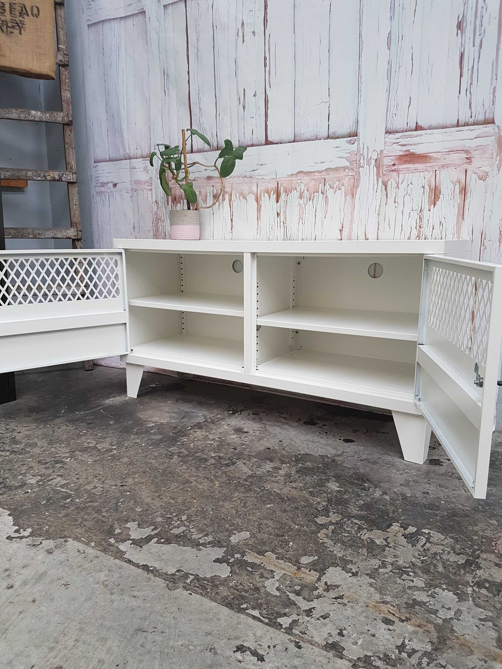 White Metal TV Cabinet. Doors open to show adjustable shelves and cable holes