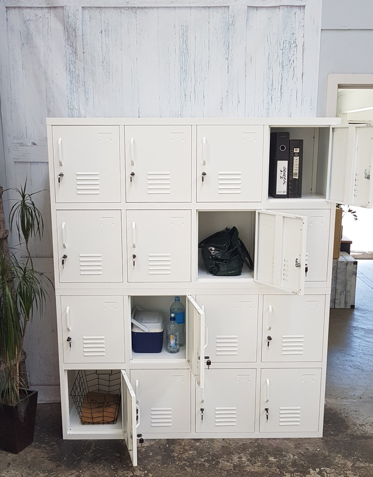 White metal 16-door staff locker with some doors open to show use