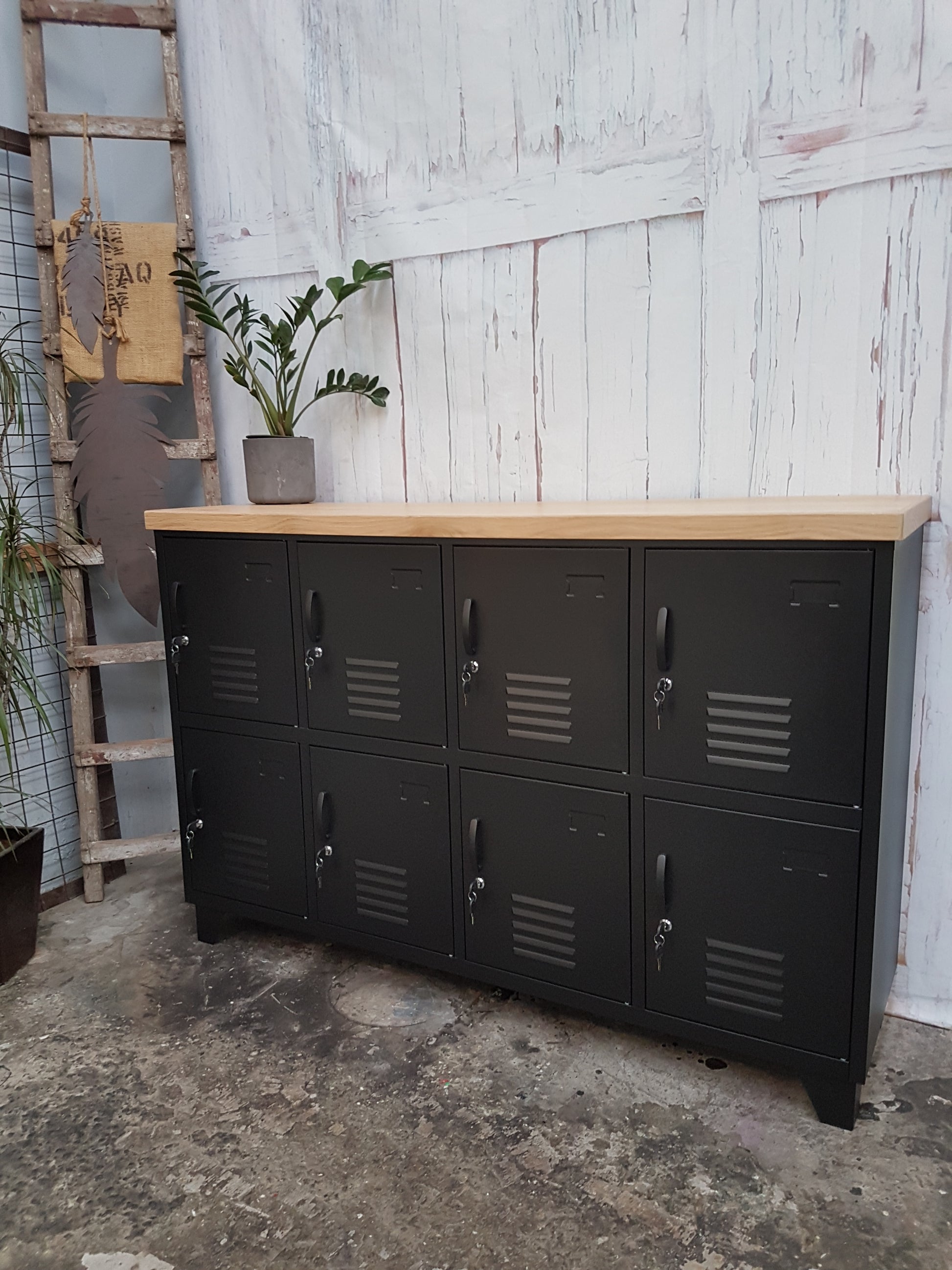 A black metal sideboard locker with an oak top, featuring multiple doors with handles.