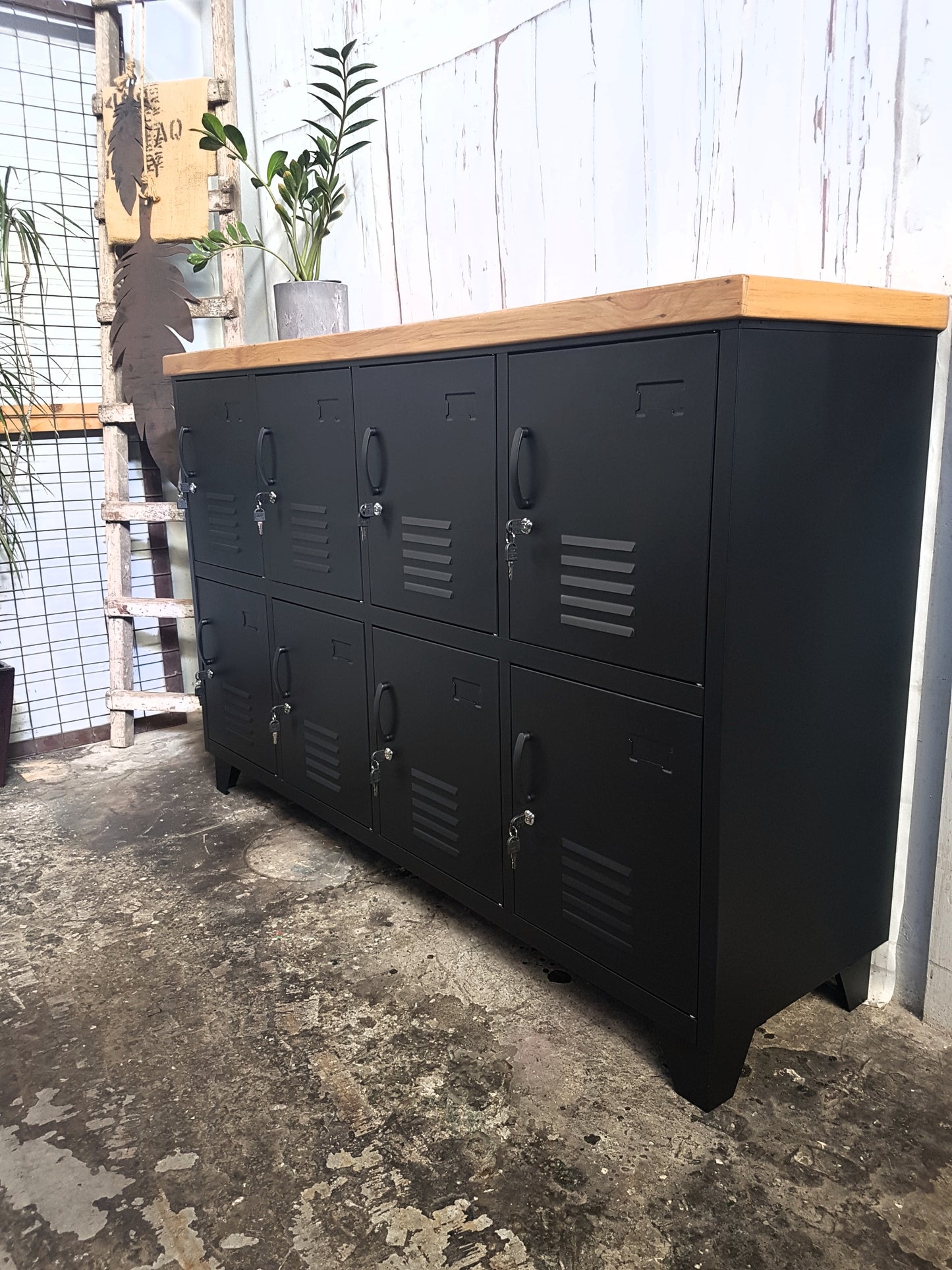 Side on view of black metal staff lockers with rimu top