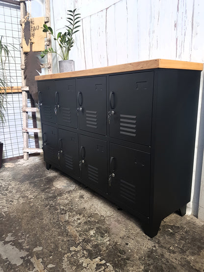 Side on view of black metal staff lockers with rimu top