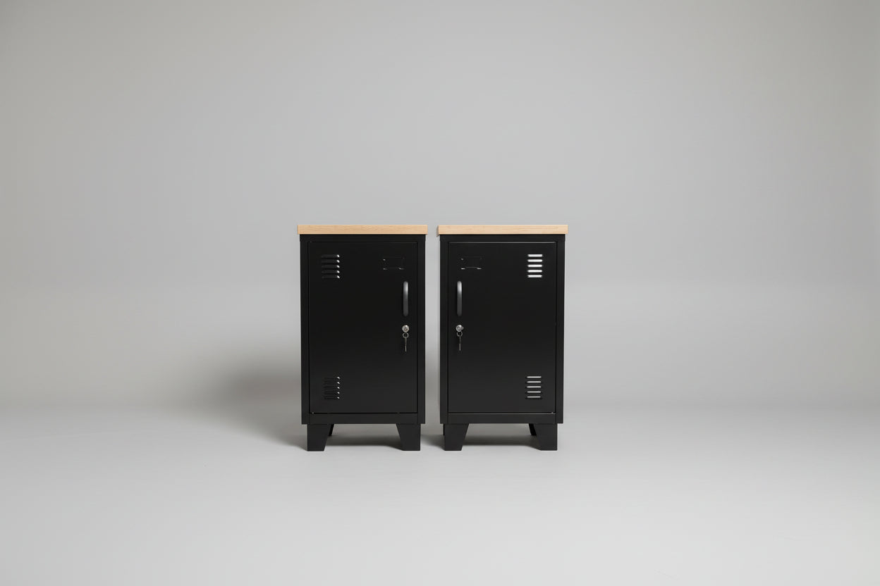 two black metal lockers with oak top in neutral background