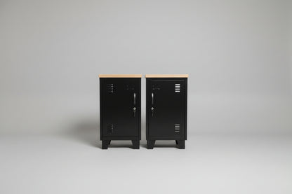 two black metal lockers with oak top in neutral background