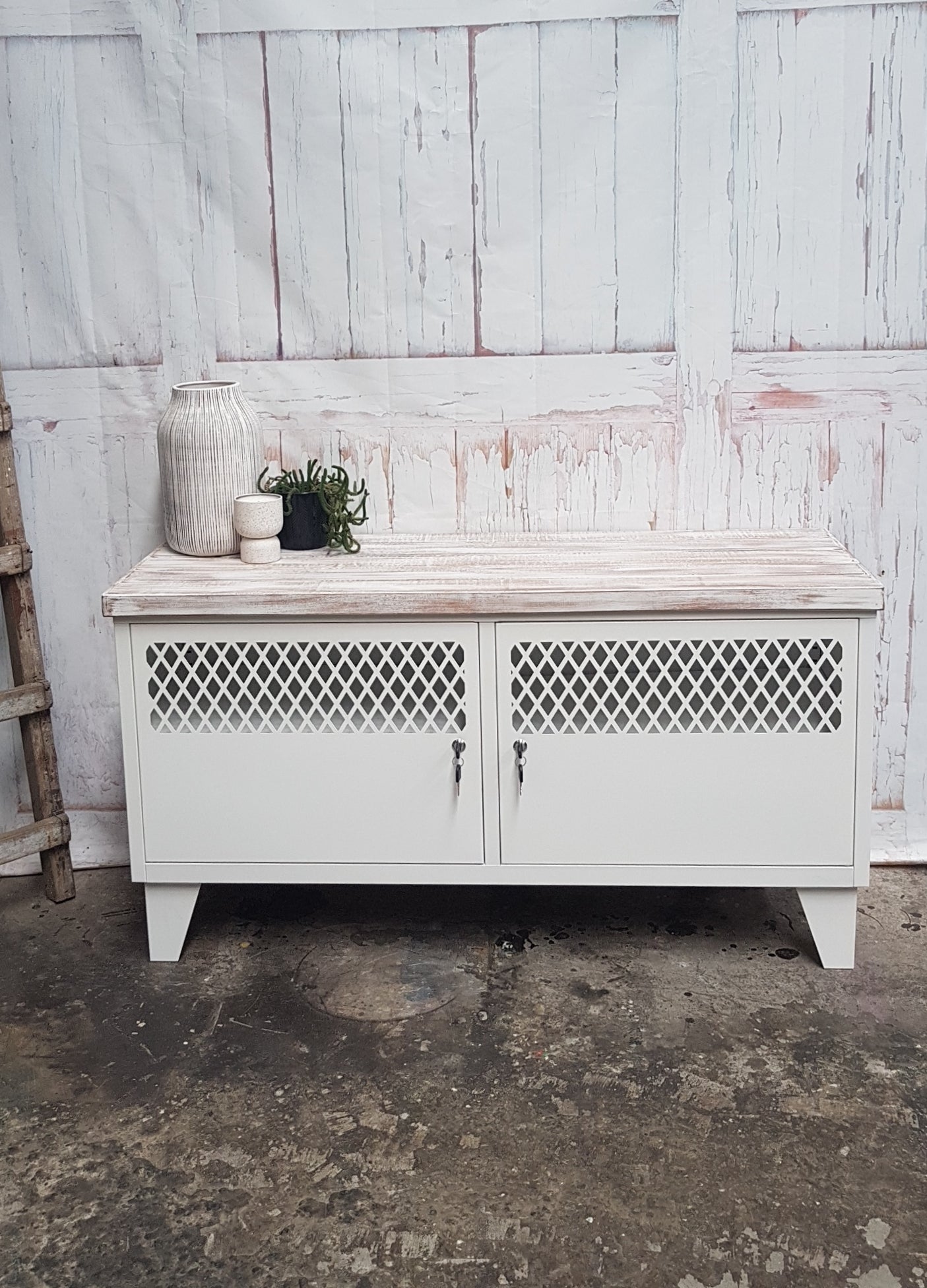 A white TV cabinet with shabby chic oak top featuring two doors, cable holes at the back, and a rustic industrial style.