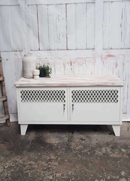 A white TV cabinet with shabby chic oak top featuring two doors, cable holes at the back, and a rustic industrial style.